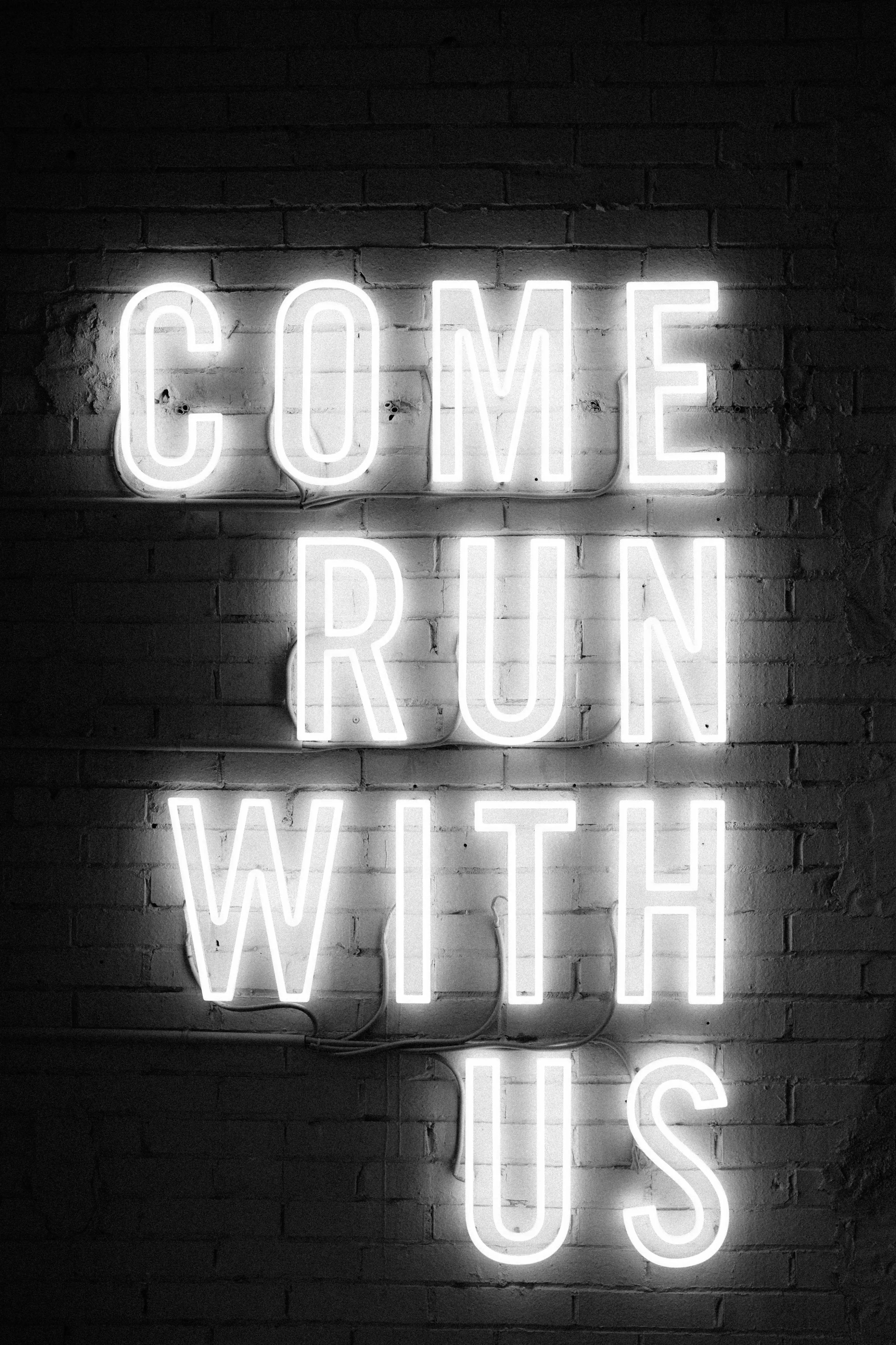 Neon sign, "Come run with us."